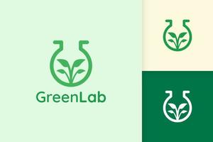 green lab logo with leaf shape for science or chemistry vector