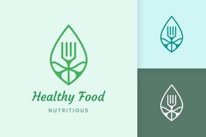 healthy food logo with fork and leaf shape vector