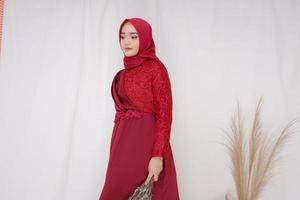 Beautiful islamic female model wearing hijab fashion, a modern lifestyle outfit for muslim woman. Concept a wedding dress, beauty or eidul fitri. A asian girl model wearing hijab on indoor photoshoot photo