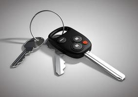 Modern Car keys for passenger vehicle isolated on flat white surface. photo