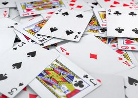 Deck of poker playing cards all suites lying on table