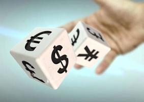 Hand throwing 2 dice with currency symbols. Concept for financial advice, trading, markets. photo