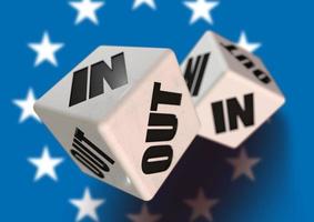 In or Out vote on dice for countries leaving the European Union with flag in the background. photo