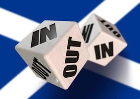 In or Out vote on dice for Scotland leaving the European Union with Scotish flag in the background. Scexit. photo