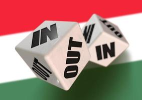 In or Out vote on dice for Hungary leaving the European Union with Hungarian flag in the background. Hexit. photo