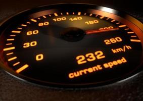 Car speedometer with bright orange illuminated dials inset in dark leather with depth of field photo