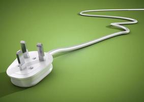 Electrical plug and cable lies unplugged isolates on green background photo