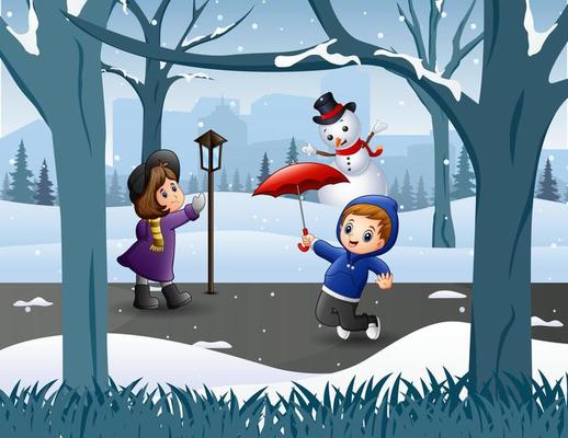 Funny kids playing in the snowy park