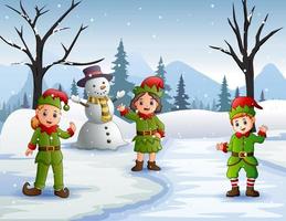 Three elves waving in the snowy forest vector