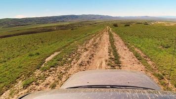 POV hyper lapse of a four-wheel-drive car on gravel dirt road in caucasus. Discovery and adventure travel concept. video