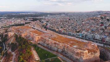Aerial static view famous landmark top Urfa castle with colorful old town tradition architecture colorful houses background