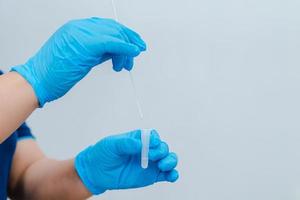 A nurse is using a cotton swab photo