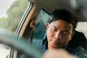 A man uses his phone while driving and falls asleep while driving. photo