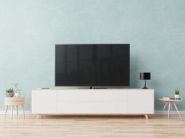 TV on the cabinet in modern living room on blue wall background.