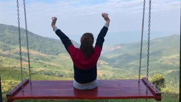 Rear View of Woman Sitting on Giant Swing and Enjoying View of Nature video