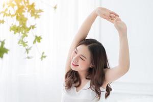 Image of young Asian woman in bed photo