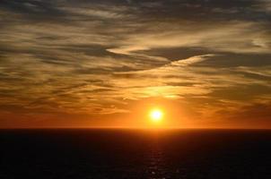 beautiful warm sunset with clouds on sea photo