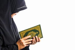 Koran in hand  holy book of Muslims public item of all muslims Koran in hand muslims woman photo