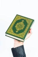 Koran in hand  holy book of Muslims  public item of all muslims photo