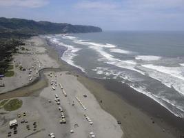 Aerial view of sandy beach Parangtritis near ocean with big wave photo