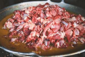 The process of cooking tongseng using a stove in close up, tongseng is traditional food from central java indonesia. thera are tongseng goat beef or chicken photo