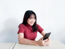 Feeling happy and smile face of Young beautiful asian woman looking on the smartphone. Indonesia women photo