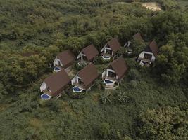 Aerial view of beautiful isolated villa with small swimming pool in the middle of a forest photo