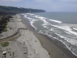 Aerial view of sandy beach Parangtritis near ocean with big wave photo