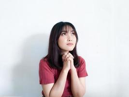 Happy beautiful asian girl wearing red sweater praying to god, Christmas concepts, Winter concepts , isolated on white background. photo