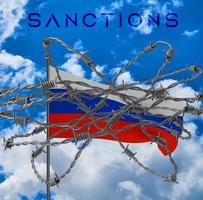 Sanctions on Russia with Russian flag on Barbed Wire photo