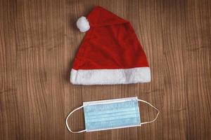 corona christmas with Santa Claus hat and face mask photo