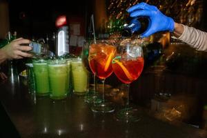 fruit alcohol cocktail based on lime, mint, orange, soda