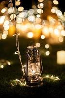 burning candles on a dark night in a wooden lantern photo