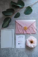 wedding invitation in a gray envelope on a table photo