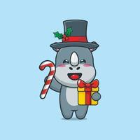 Cute rhino holding christmas candy and gift vector