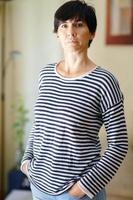 Middle-aged woman posing at home looking at the camera with serenity. photo