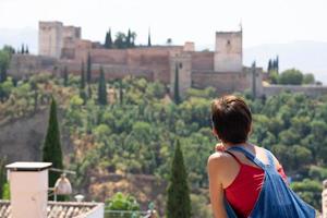 Rear view of woman looking at the Alhambra of Granada.