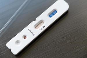 Positive test result by using rapid test device for COVID-19 photo