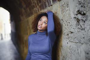 Young girl with afro hairstyle in urban background photo