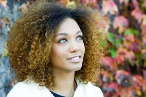 Young African American girl with afro hairstyle and green eyes photo