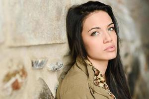 Young woman with green eyes in urban background photo