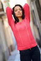 Young woman with green eyes in urban background photo