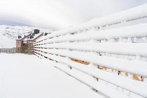 Winter mountains landscape with snowed fence in Sierra Nevada