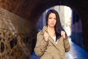 Young woman with green eyes in urban background photo
