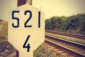 Stone signal in the railway line. Retro vintage style. Horizontal image. photo