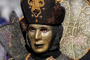 Venice, Italy, 2013 - Unidentified person with Venetian carnival mask in Venice, Italy. At 2013 it is held from January 26th to February 12th. photo