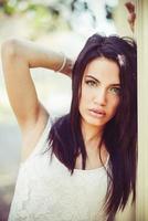 Young woman with green eyes in urban background photo