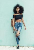 Young mixed woman with afro hair standing on the street photo