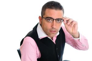 Successful businessman with glasses wearing vest and pink shirt photo
