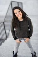 Young woman with green eyes in urban background photo